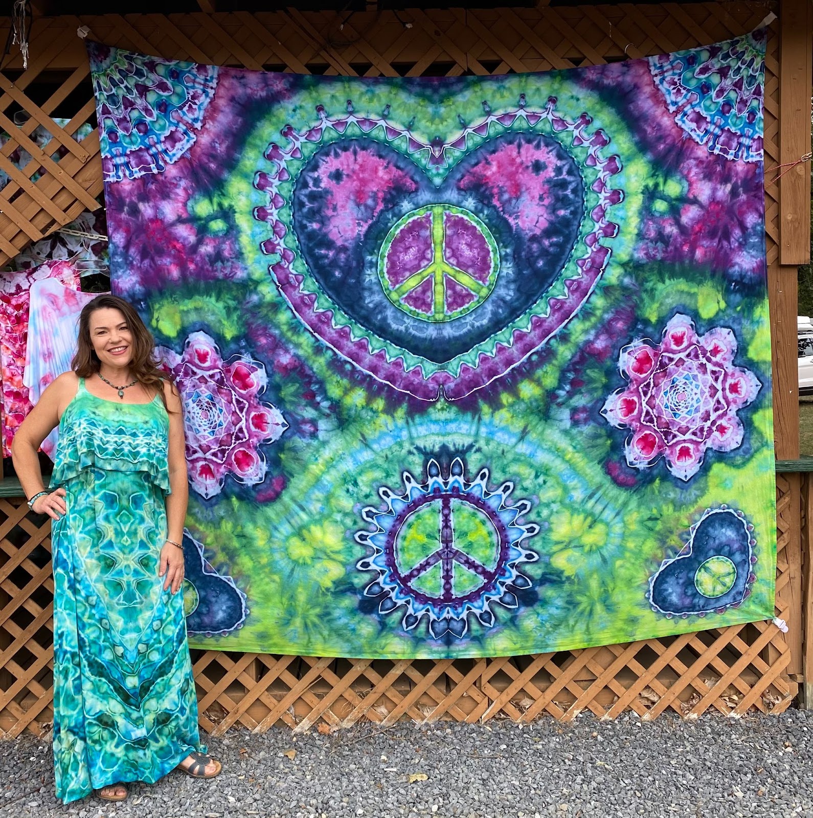 How is this tapestry possible?! Patsy wears a dress she double-dyed next to her tapestry taken at the Greencastle American Legion Picnic Grounds last year. 