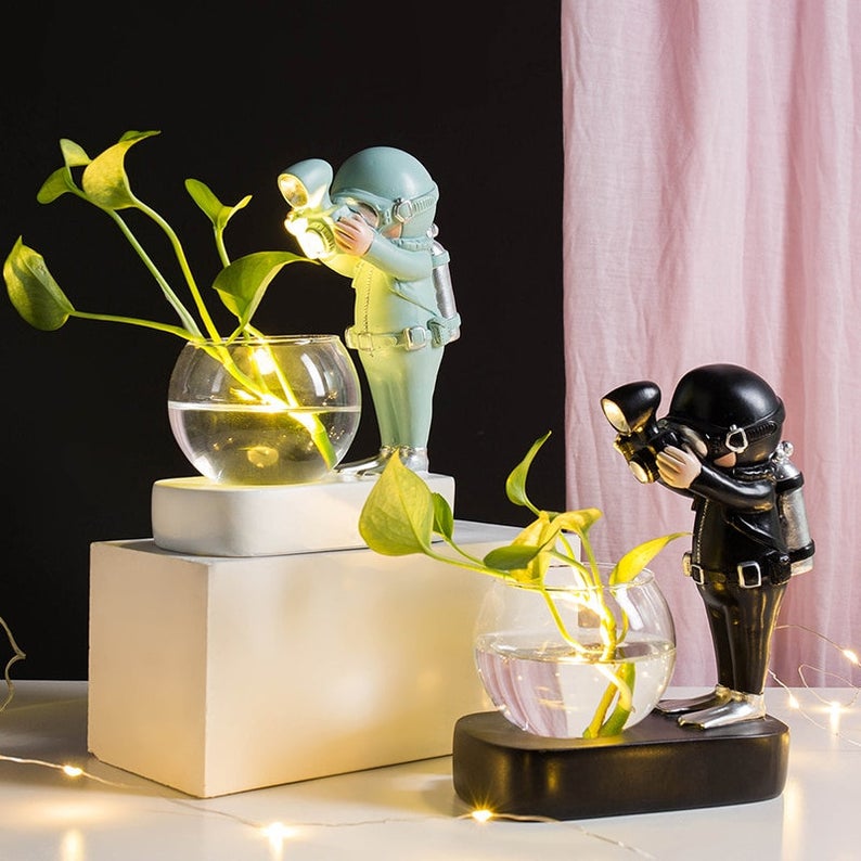 two light up flower vases with divers