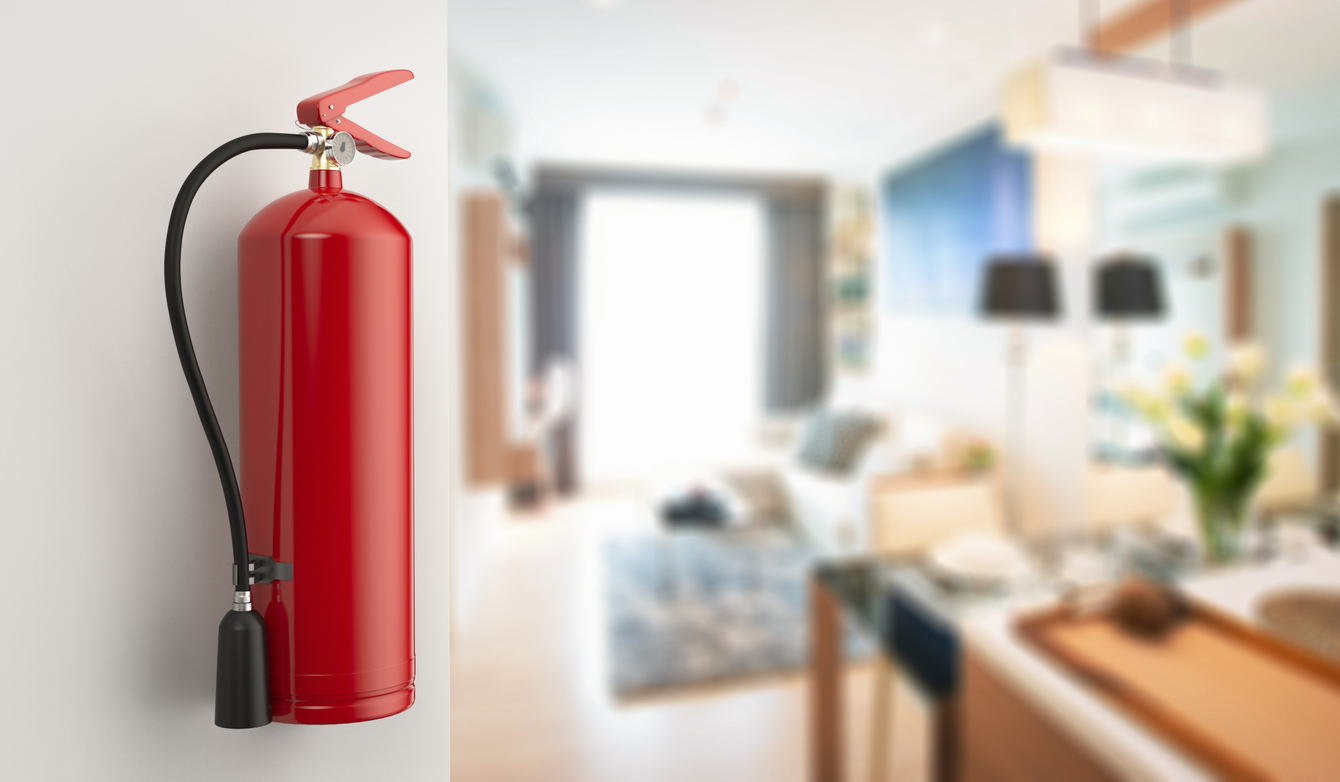 red fiier extinguisher on the wall in a property.