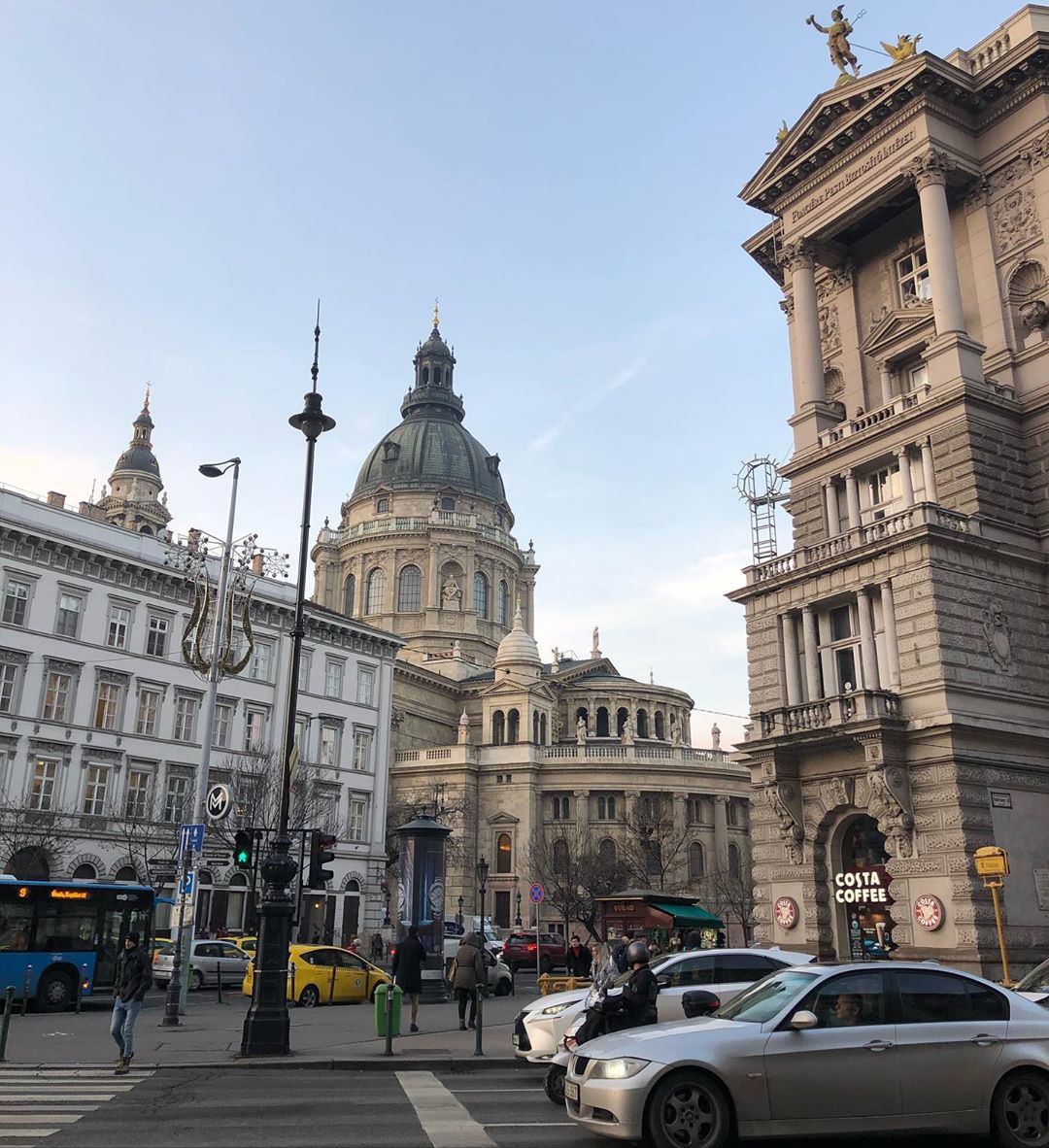 Andrassy avenue, lined by trees and crowded with cars and passers-by