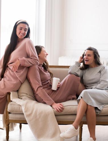 A group of women sitting on a couch

Description automatically generated