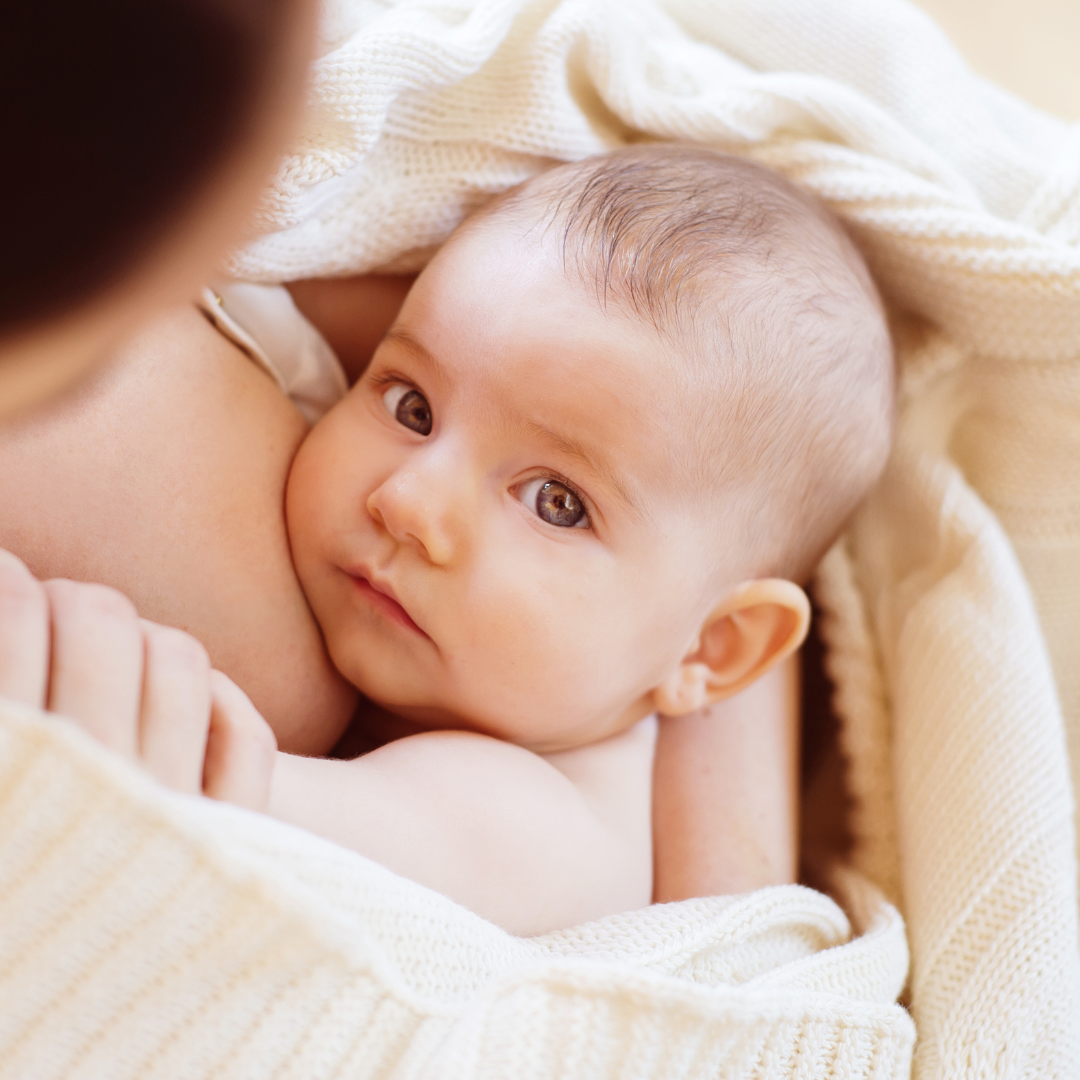 Baby looking at his mom with no expression on his face