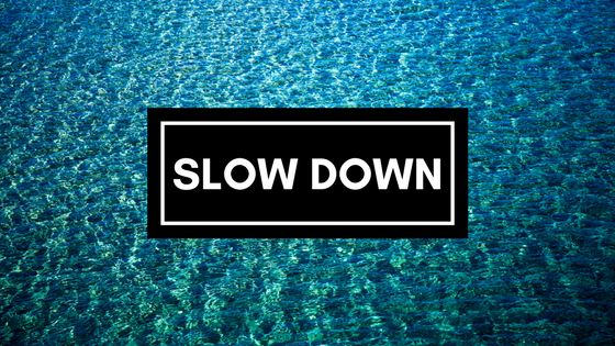 SLOW DOWN text on field of water