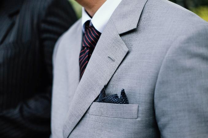 A person wearing a suit and tie

Description automatically generated