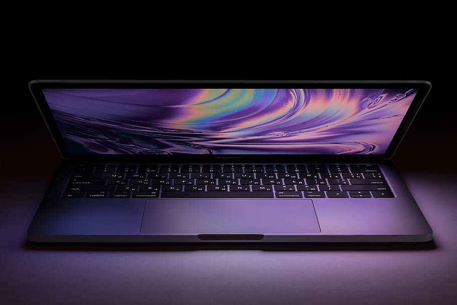 This image shows the MacBook Pro in the curved shape in the colorful shade.