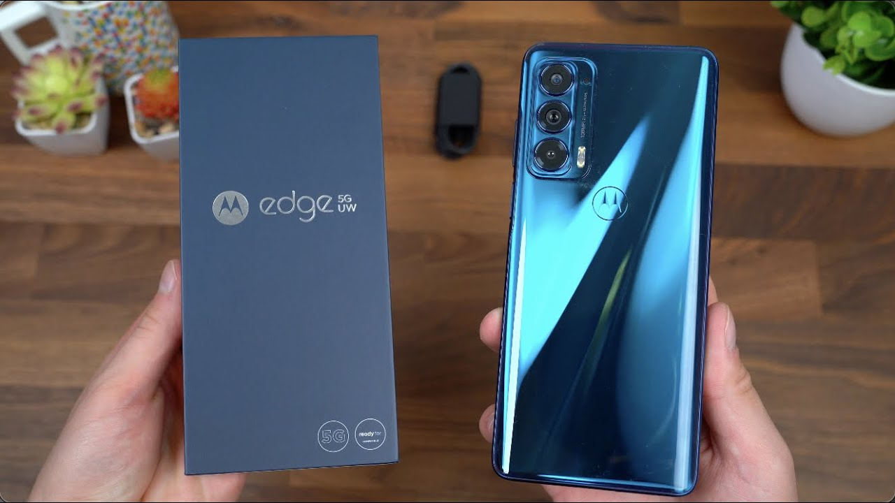 This image shows the Motorola Edge+ 5G UW 2022 with its box in the hands of a man.