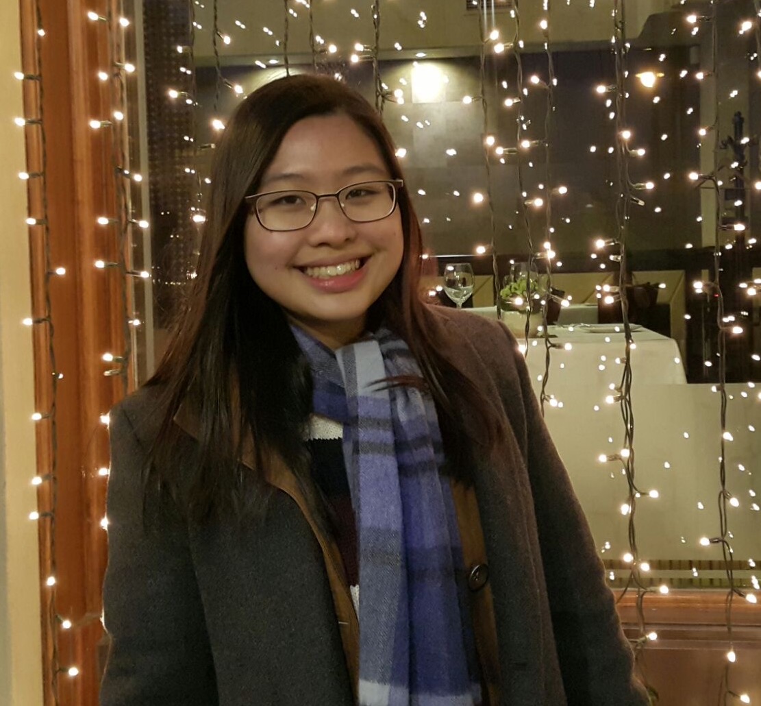 Female wearing glasses with long dark brown hair. 