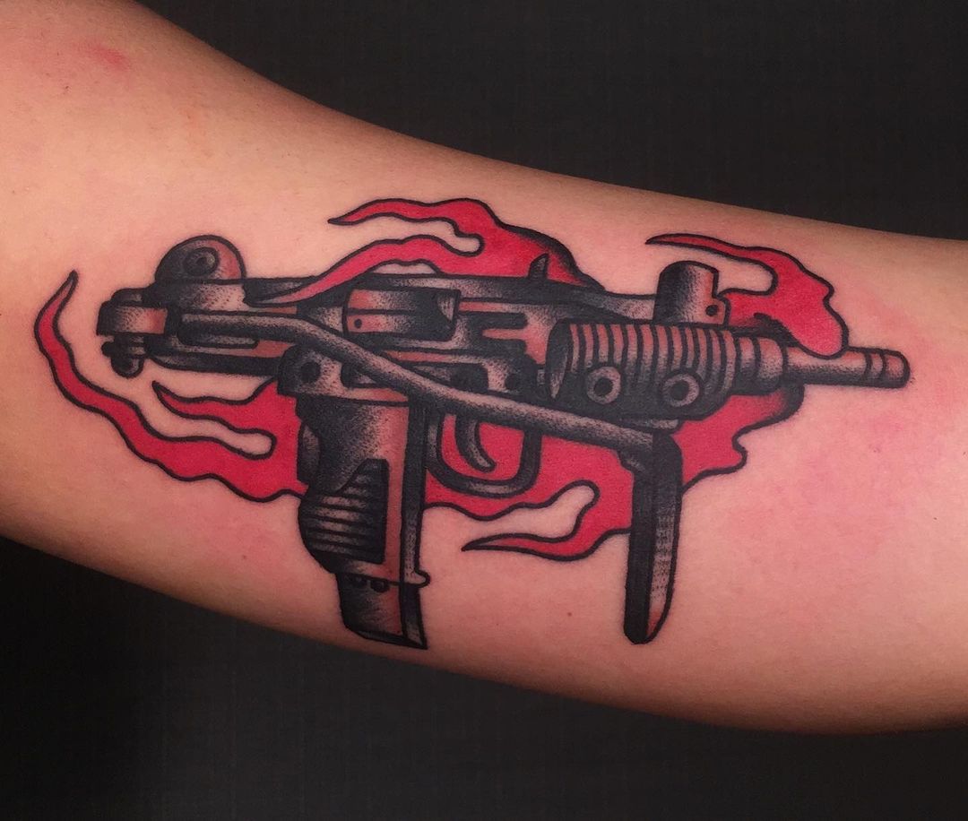 Pistols With Flame Tattoos On Hips