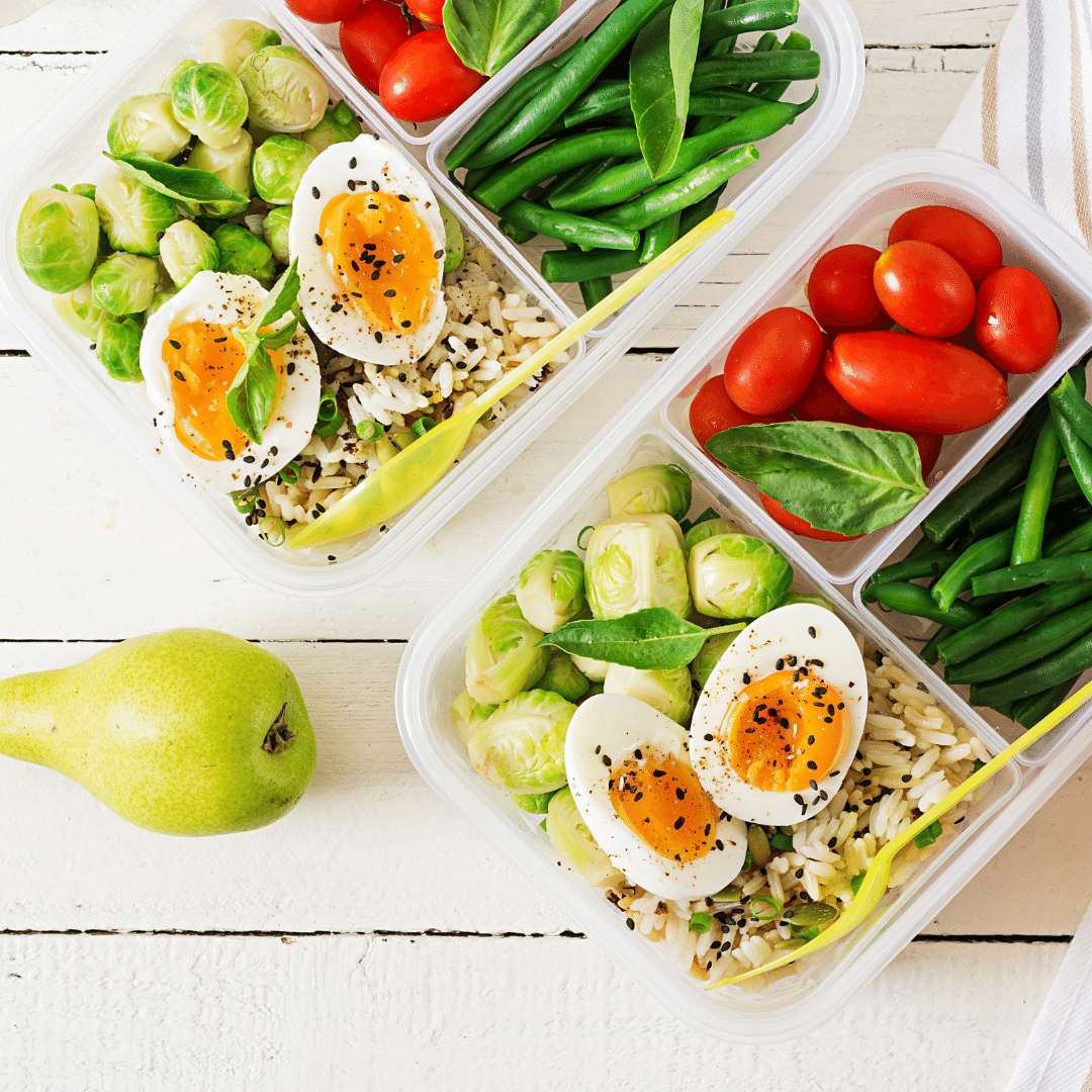 Lunchbox ideas for adults: Boiled eggs, rice, roasted Brussel sprouts, green beans, tomatoes, pear, chocolate