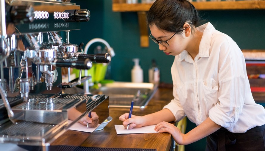young girl working as a barista 