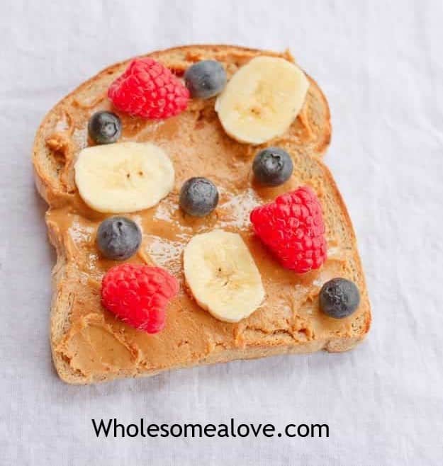 Peanut butter with raspberries, bananas, and blueberries is a healthy breakfast idea