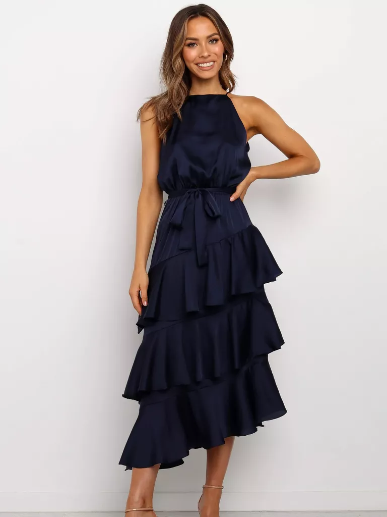 a lady wearing a navy blue ruffle guest wedding dress for winter