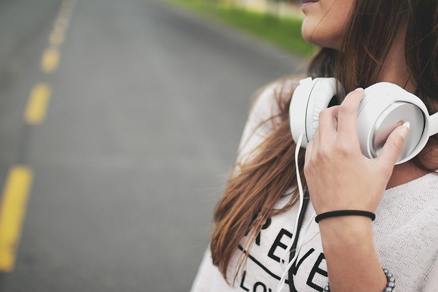 a teenager with her headphones for music - things to do on a car trip with a teenager