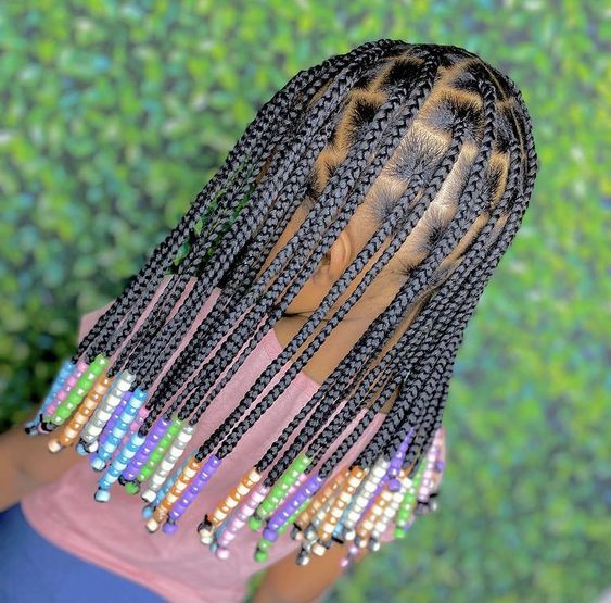 Back view of a beautiful child rocking her braids with beads