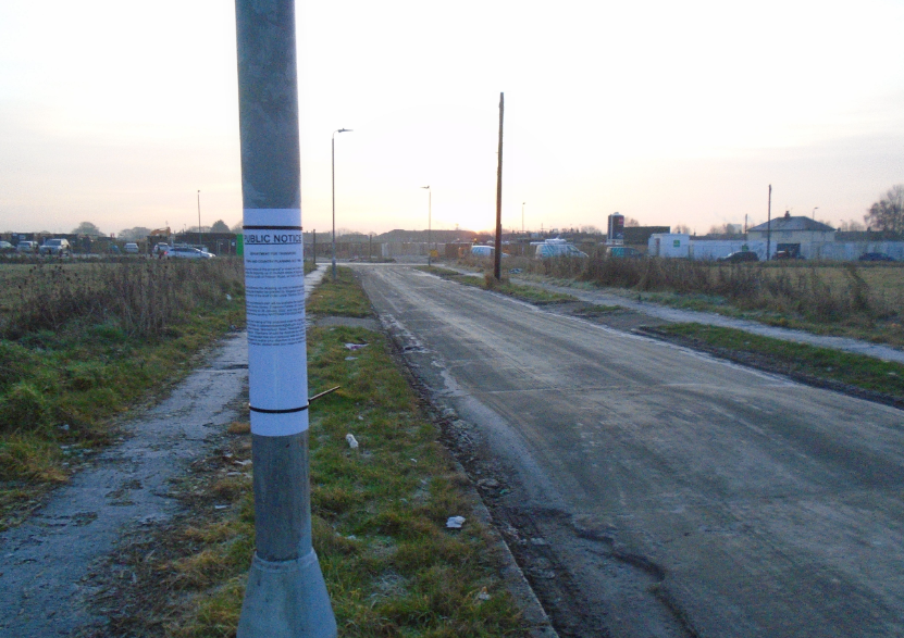 A road with a pole and grass

Public Notices posted on site where it is proposed to stop up the highway.