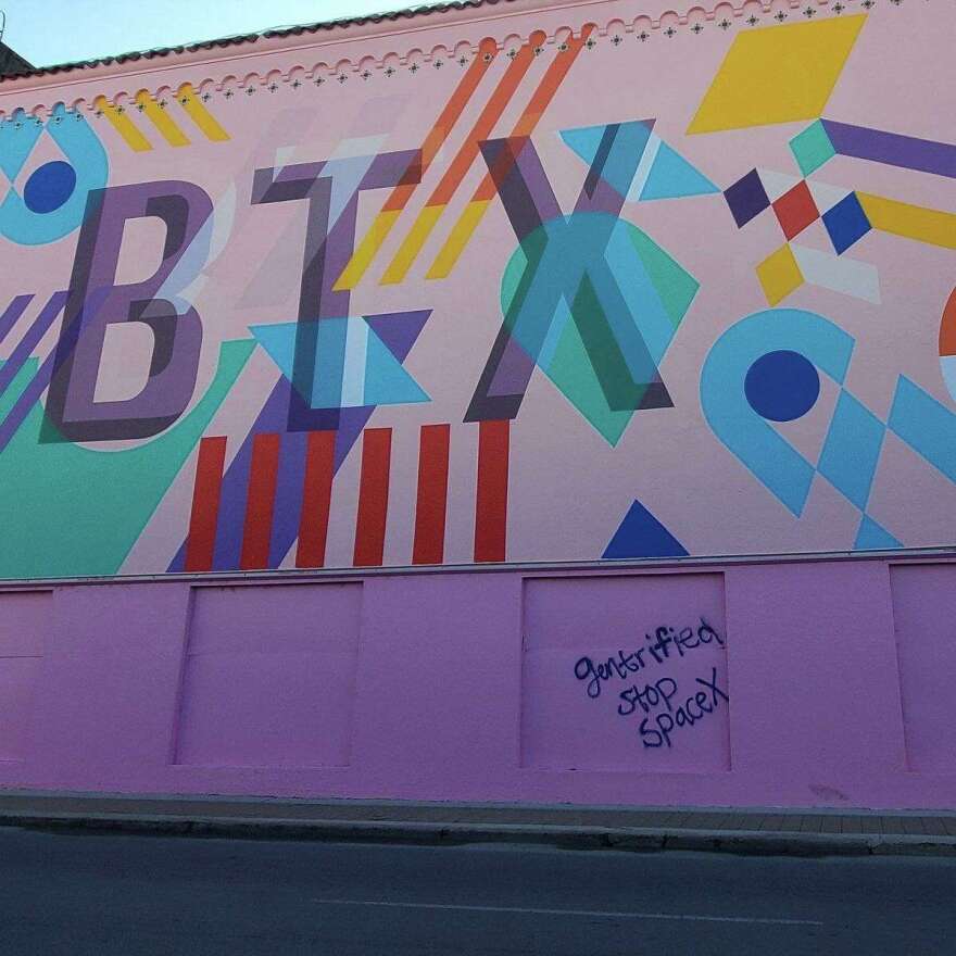 Image of downtown Brownsville mural with the words “gentrified stop SpaceX” graffitied under it, via Trey Mendez’s Facebook Page