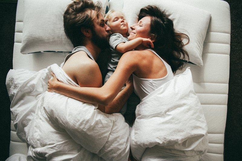 parents enjoying co-sleeping with baby