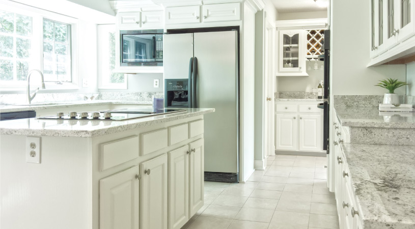 A kitchen decked out in an all white-color scheme — a popular design trend in 2022.