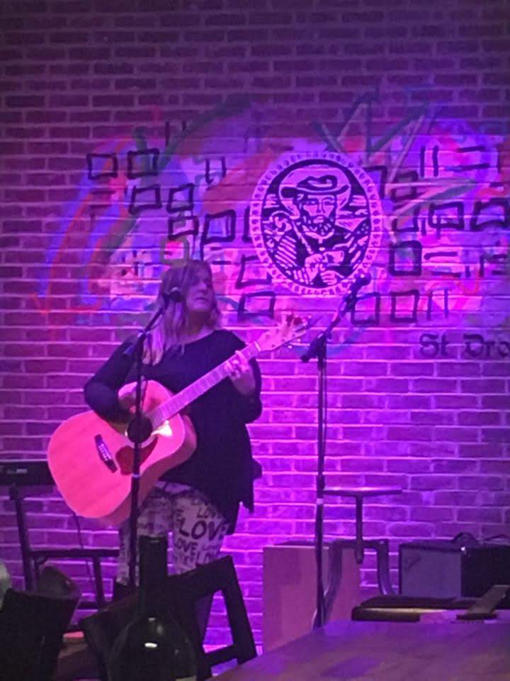 photo of anne chance playing guitar onstage 