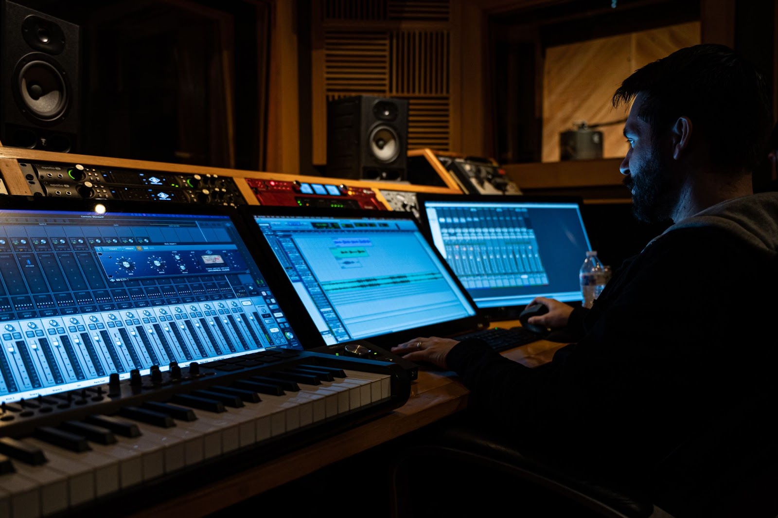  A man in music studio producing using sound mixers-What Makes A Hit Song – Secrets You Should Know