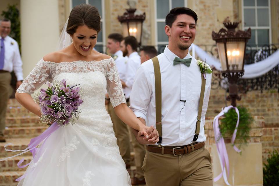 Image may contain: 3 people, people smiling, people standing and wedding