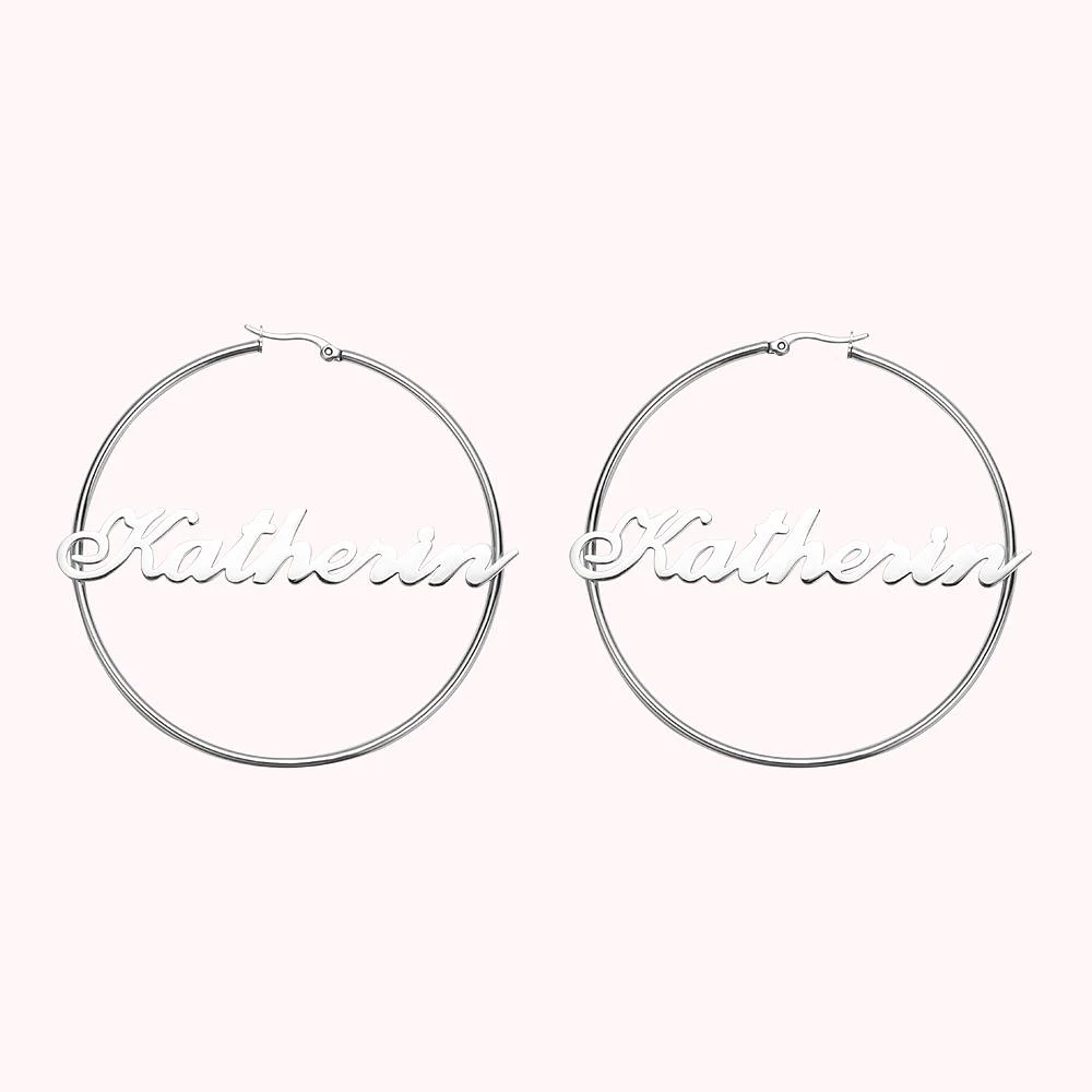 Boucles d’oreilles en argent, de forme ronde, personnalisées par un prénom.