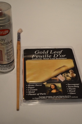 spray adhesive, gold or silver leaf, a paintbrush