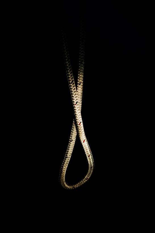 gold-colored necklace on black background