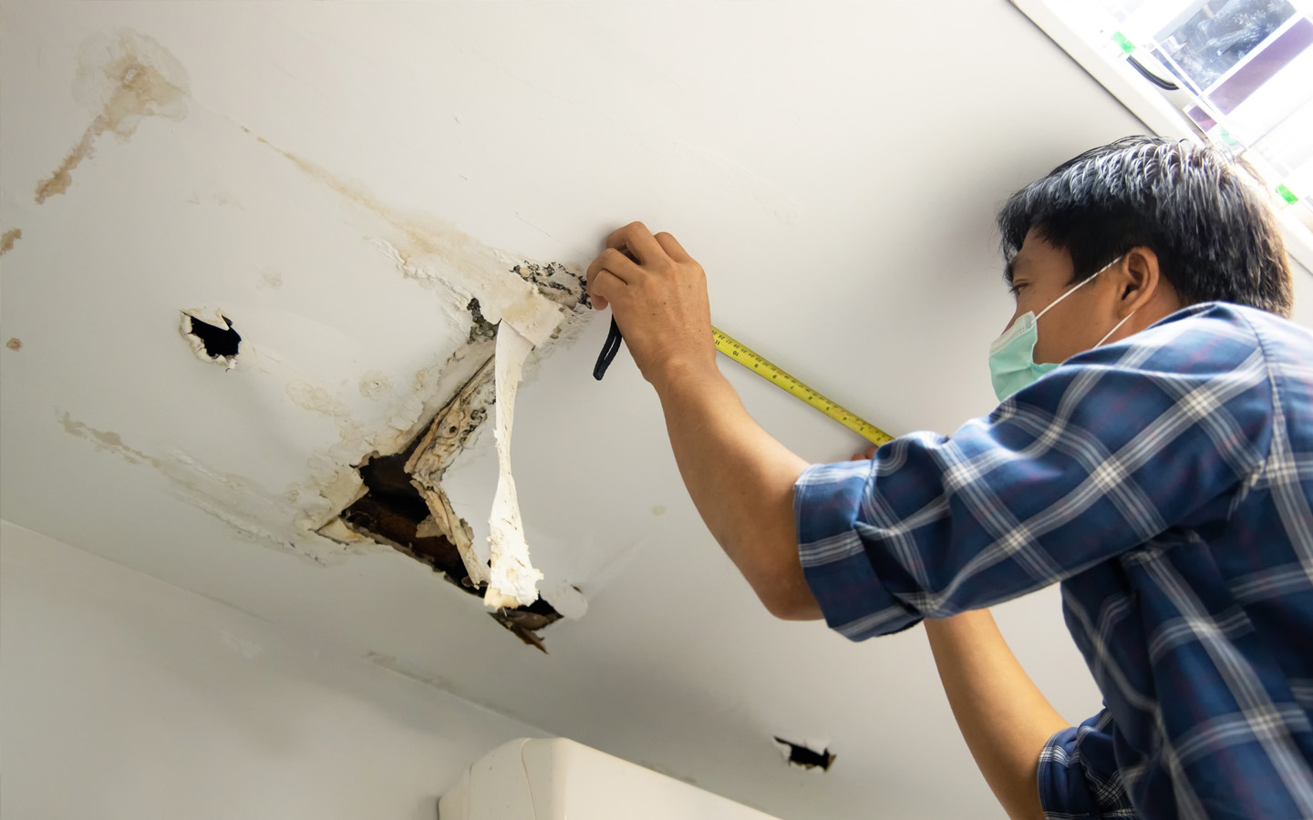 man fixing ceiling