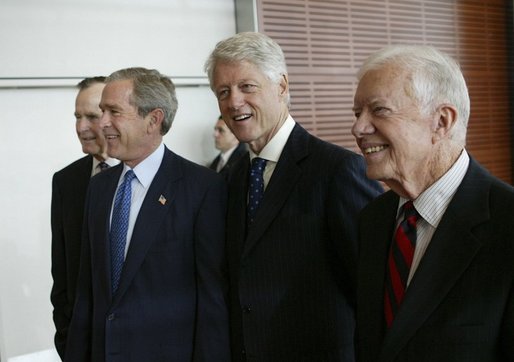 Bill Clinton with former Presidents George Bush Sr. (R), George Bush Jr. (R), and Jimmy Carter (D)
