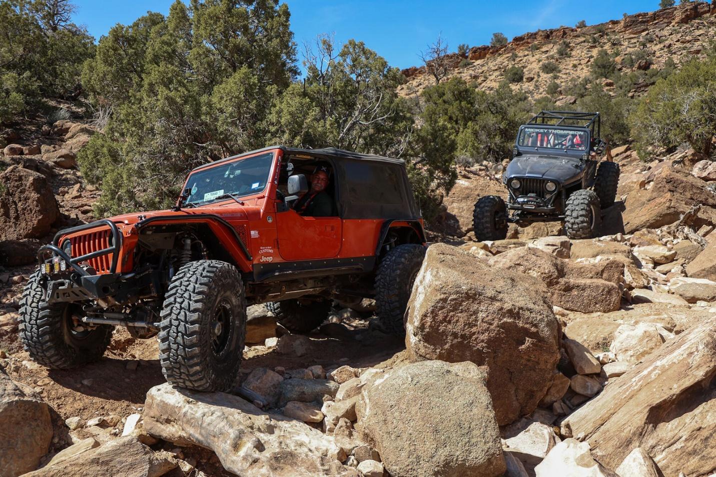 An off road park with 2 jeeps crawling rocks 