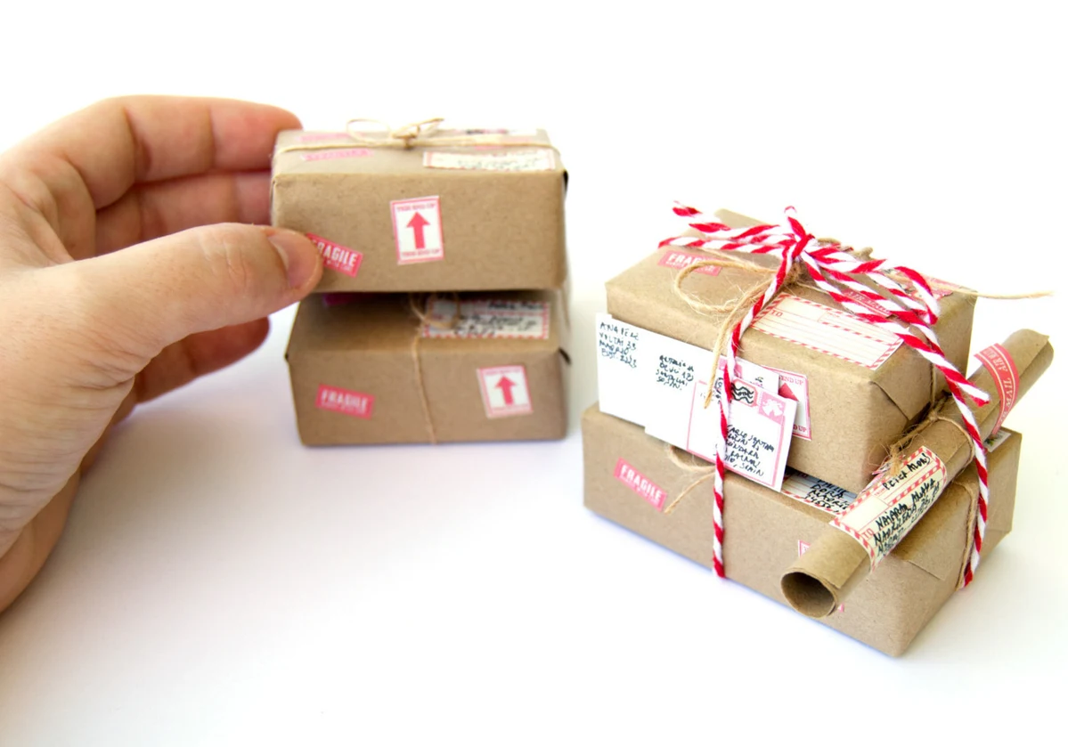 4 mini packages held by a person 