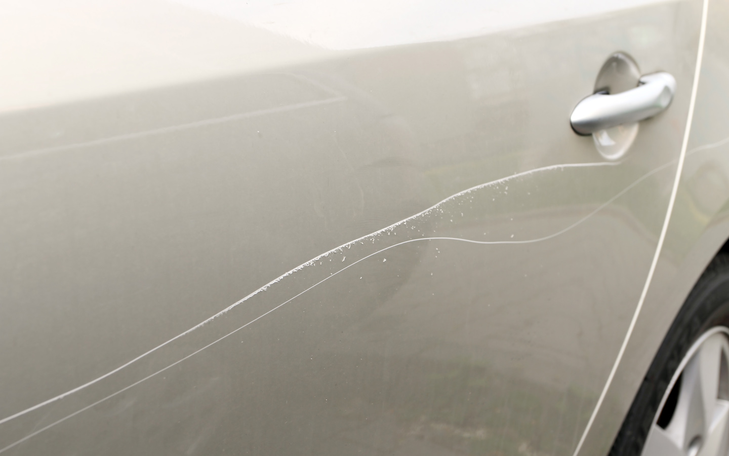 types of car scratches: scratch on car door