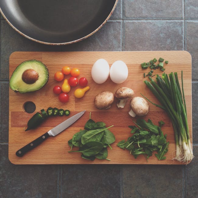 Eggs Avocado Mushroom Basil and Onion Springs on Wooden Chopping Board