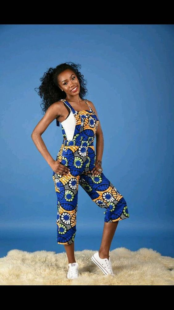 smiling lady wearing ankara dungaree over a white tank top