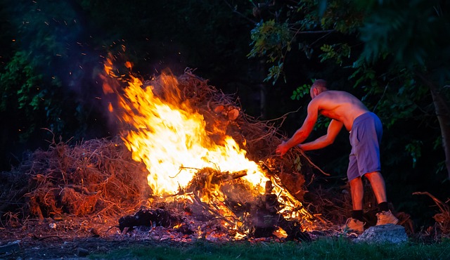 man making a bon fire - things to do while camping for dults