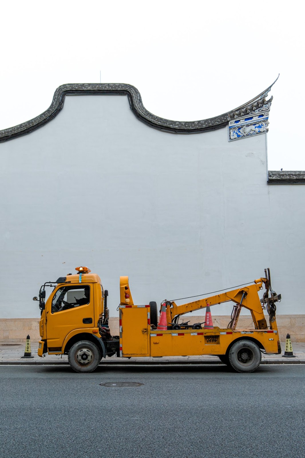 A side profile of a yellow tow truck