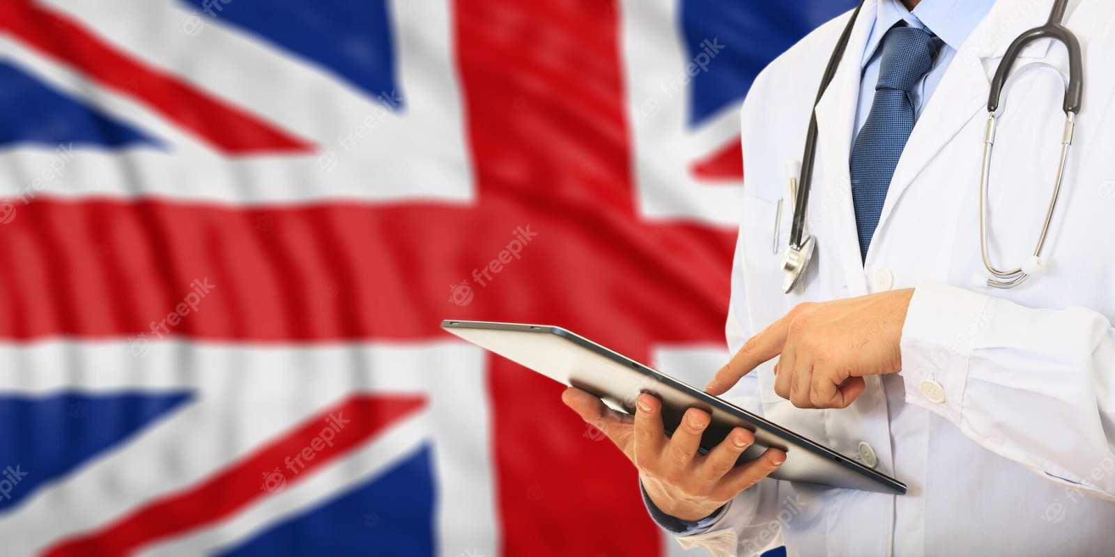 Malaysian medical student with a stethoscope stands near the UK flag, symbolising their aspiration to study medicine in the UK.