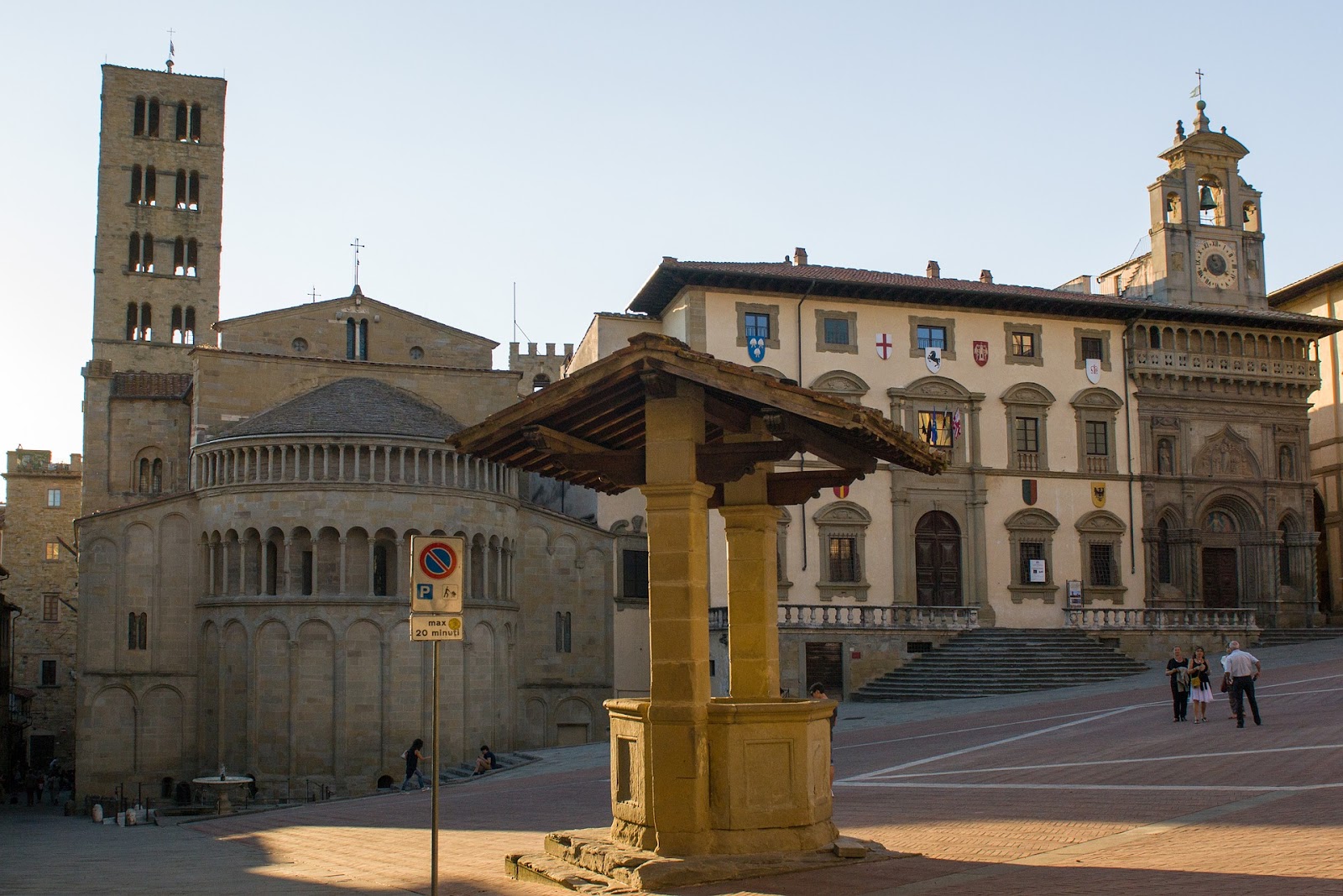 empty piazza grande main square in italy well in foreground and medieval  buildings in background during sunrise in arezzo italy