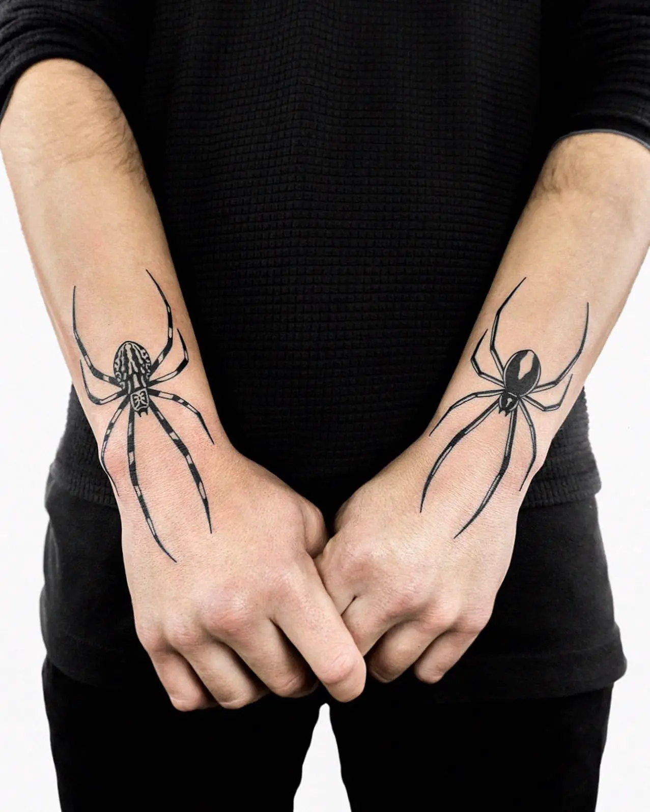 Full picture showing a guy rocking the spider tat on his forearms