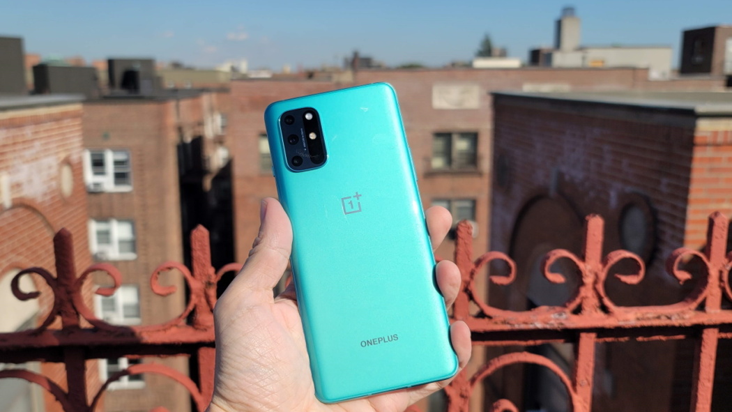This image shows the OnePlus 8T+ 5G in the hands of man under sunshine.