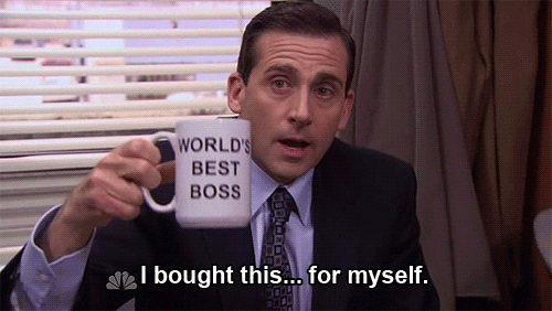 Michael Scott from the Office holding up a World's Best Boss coffee mug and saying "I bought this for myself." 