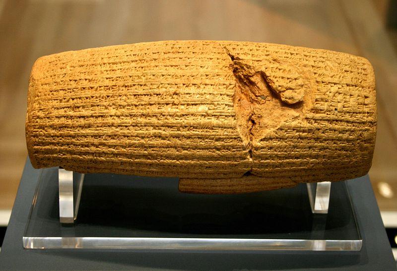 The Cyrus Cylinder: a rounded cylinder of stone with cuneiform script carved into it on all surfaces.