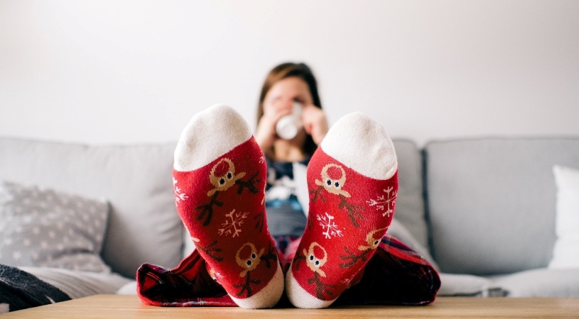 woman relaxing after sorting out all of her last-minute gifts