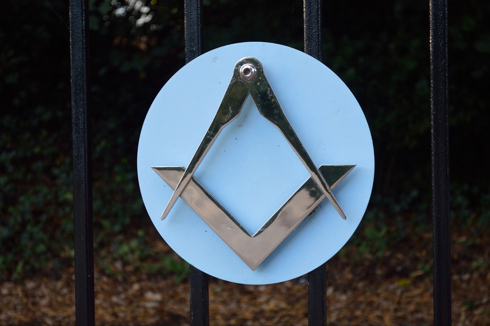 Square and compasses emblem on the gate of Freemasons Hall, England