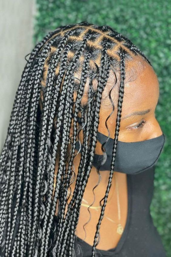 Side view of a lady rocking the bohemian braids style 