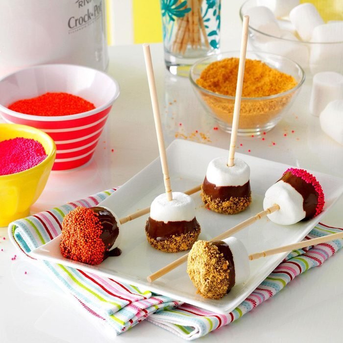 Marshmallows on a stick covered in chocolate. 