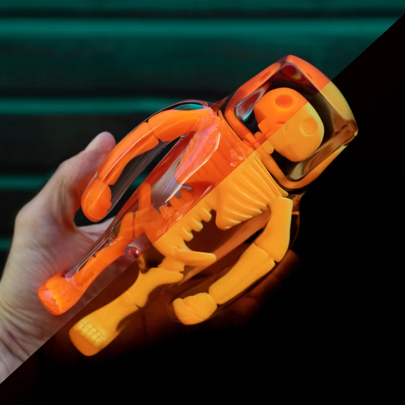 A picture containing toy, person, orange, hand

Description automatically generated