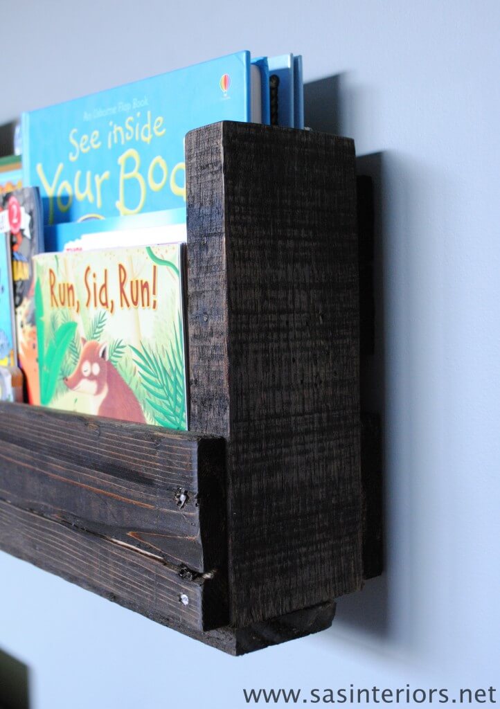 Pallet bookshelf with dark stained wood holding children's books