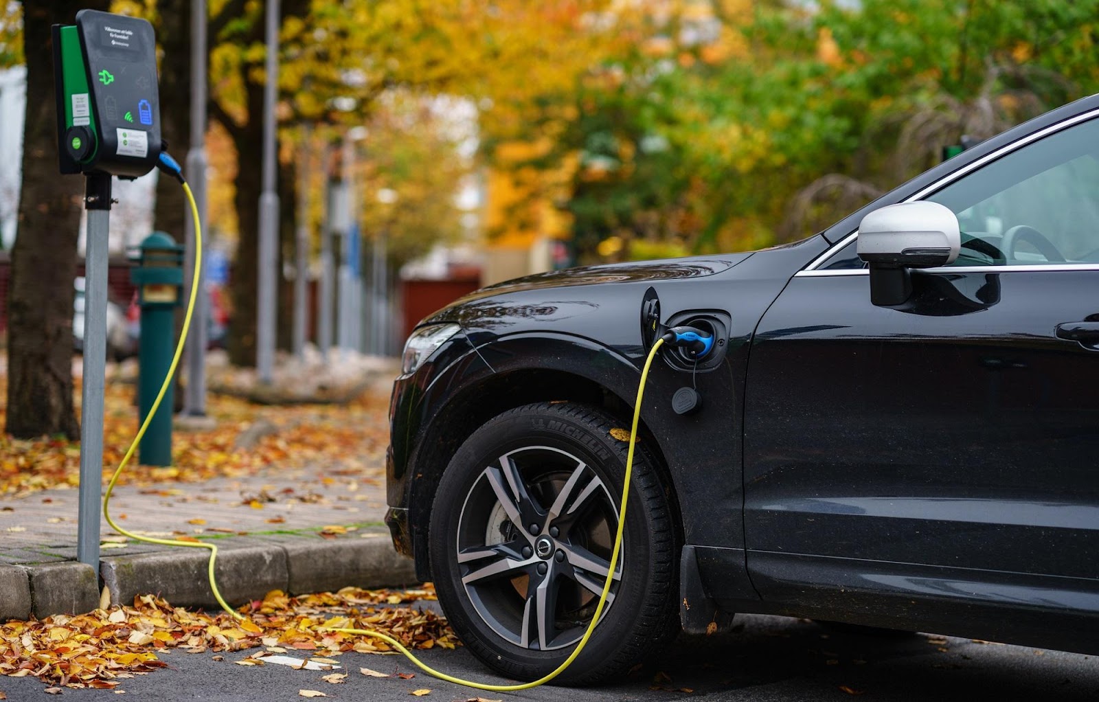 an electric car being charged at a charging station.
